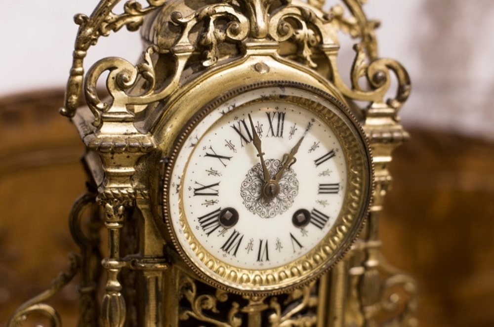 Checking The Condition Of An Antique Grandfather Clock's Movement